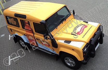 Land Rover Defender wrapped in printed yellow design by Totally Dynamic South London