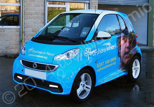 Smart Car fully vinyl wrapped in a printed design for Orphans in Need by Totally Dynamic Leeds