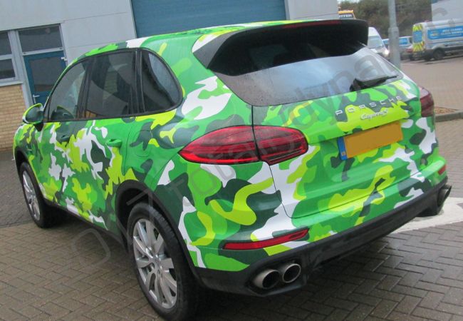 Porsche Cayenne vinyl wrapped in a printed green camouflage design