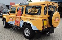 Land Rover Defender wrapped in printed yellow design by Totally Dynamic South London