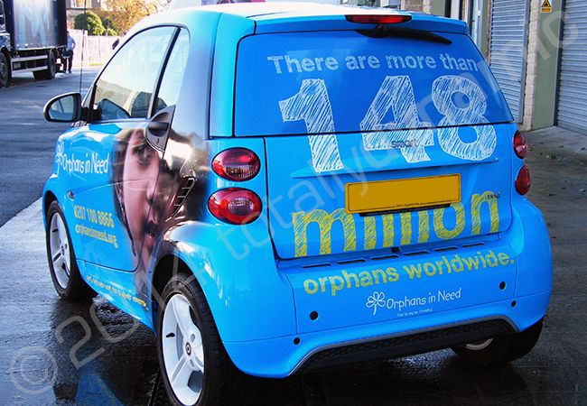 Smart Car fully vinyl wrapped in a printed design for Orphans in Need by Totally Dynamic Leeds
