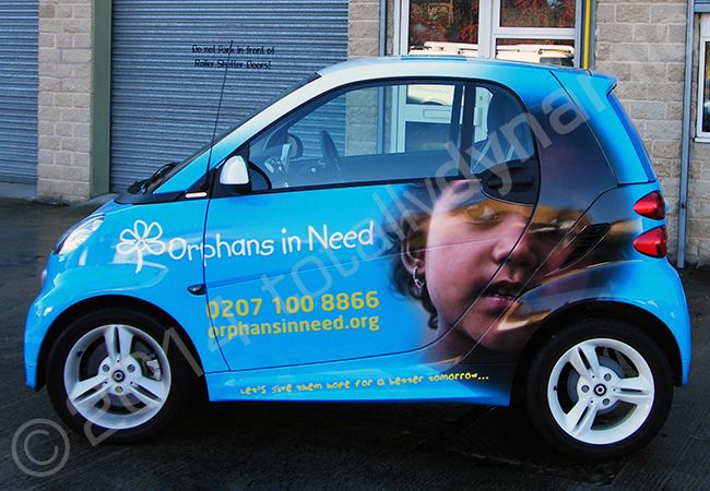 Smart Car fully vinyl wrapped in a printed design for Orphans in Need by Totally Dynamic Leeds