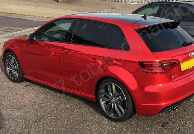 Audi S3 fully wrapped in a red chrome vinyl car wrap