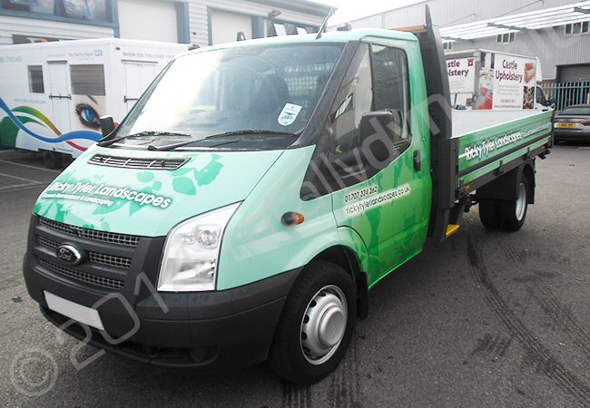 Ford Transit flatbed truck fully vinyl wrapped in a printed vehicle wrap design by Totally Dynamic North London
