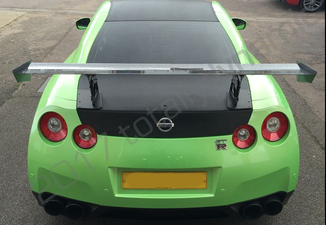 Nissan GTR vinyl wrapped in a pearlescent green car wrap with carbon fibre vinyl detailing
