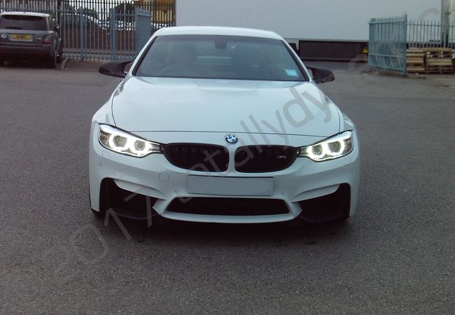 BMW M4 fully vinyl wrapped in a matt military green car wrap
