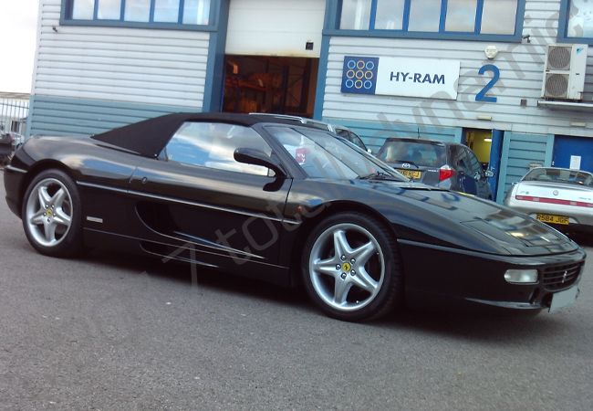 Ferrari F355 Spyder vinyl wrapped in a metallic black car wrap