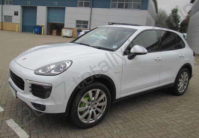 Porsche Cayenne vinyl wrapped in a printed green camouflage design