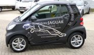 Smart car wrapped in matt black vinyl with chrome vinyl lettering by Totally Dynamic Milton Keynes