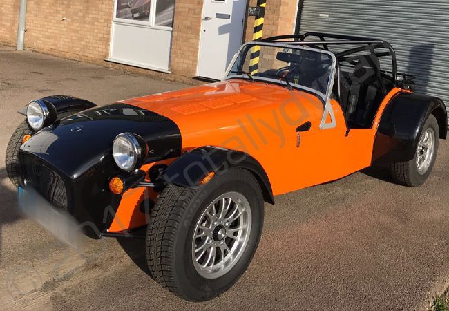 Caterham vinyl wrapped in a gloss orange car wrap
