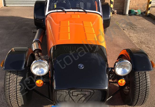 Caterham vinyl wrapped in a gloss orange car wrap