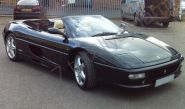 Ferrari F355 Spyder vinyl wrapped in a metallic black car wrap