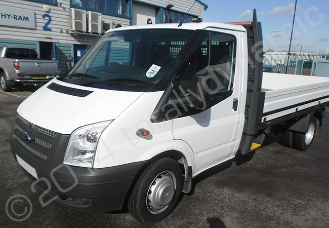 Ford Transit flatbed truck fully vinyl wrapped in a printed vehicle wrap design by Totally Dynamic North London