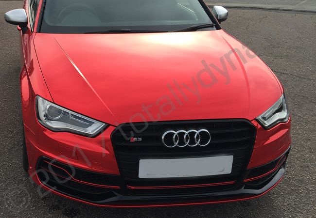 Audi S3 fully wrapped in a red chrome vinyl car wrap