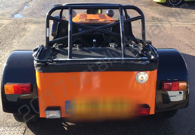 Caterham vinyl wrapped in a gloss orange car wrap