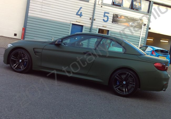BMW M4 fully vinyl wrapped in a matt military green car wrap