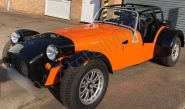 Caterham vinyl wrapped in a gloss orange car wrap