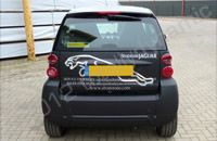 Smart car wrapped in matt black vinyl with chrome vinyl lettering by Totally Dynamic Milton Keynes