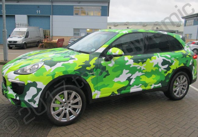Porsche Cayenne vinyl wrapped in a printed green camouflage design